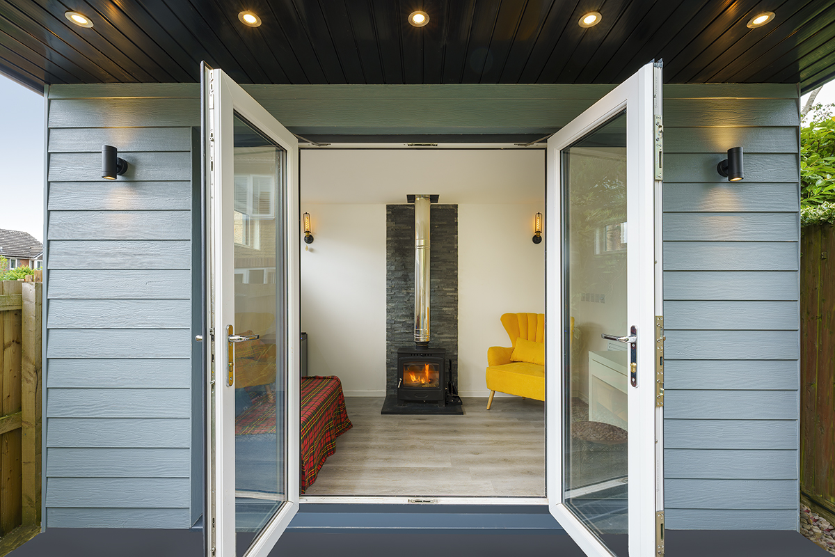 A cozy small room featuring a fireplace and a door leading to the outside.